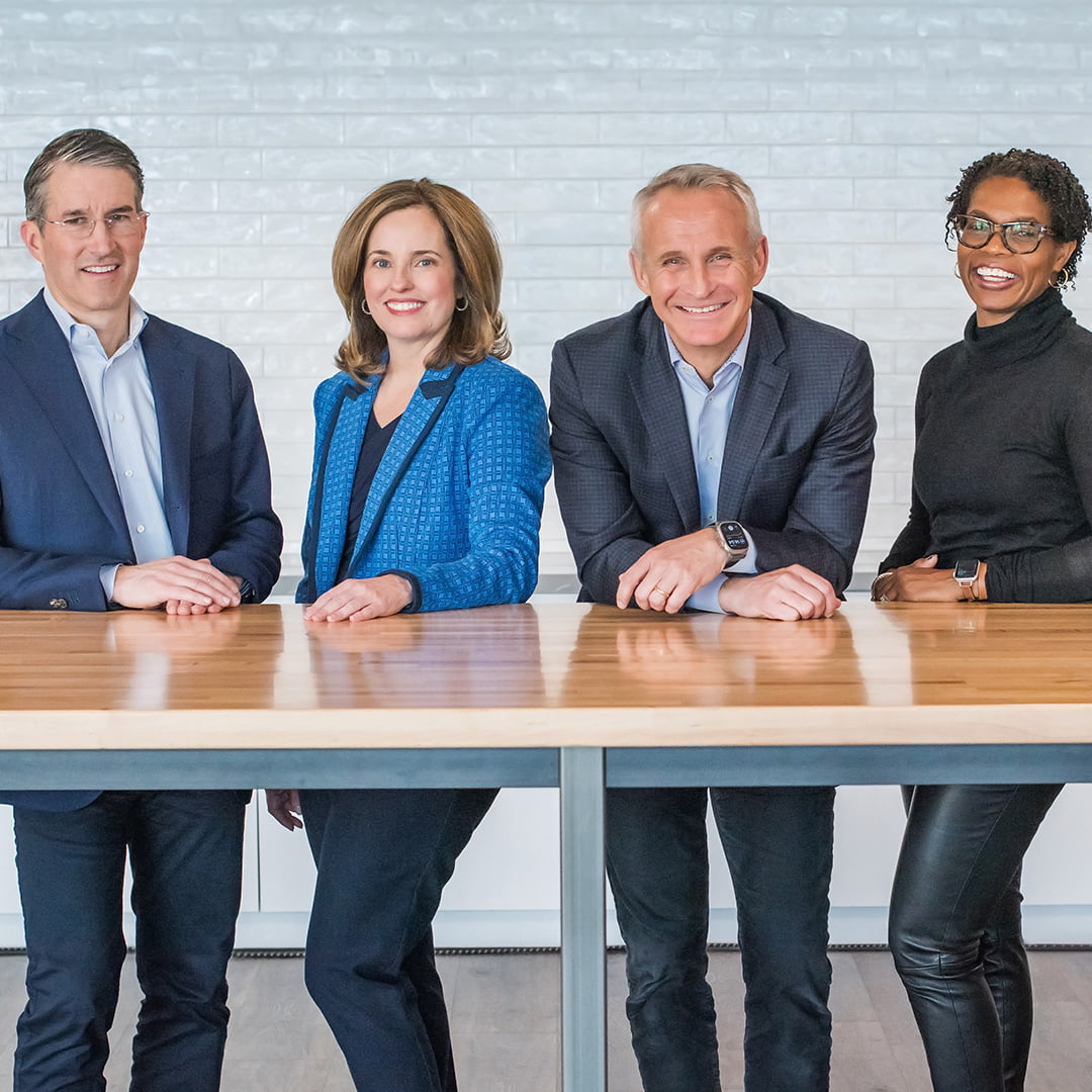 ManpowerGroup Executives standing at a table